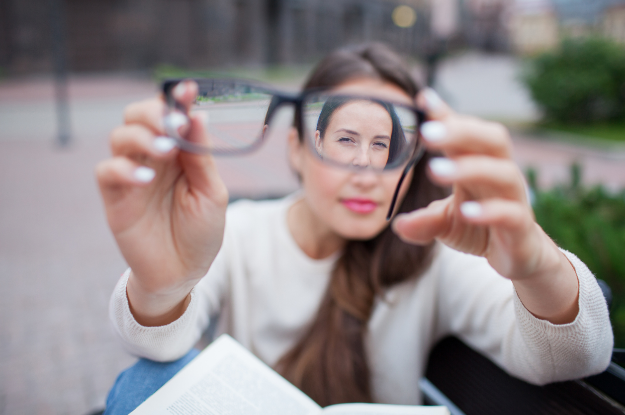 woman looking through glasses